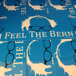 Blue stickers with glasses and 'Feel The Bern' text on a blue background