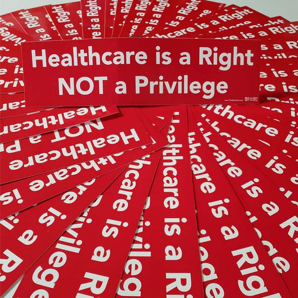 Stack of red bumper stickers with 'Healthcare is a Right NOT a Privilege' text.