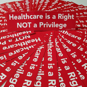 Stack of red bumper stickers with 'Healthcare is a Right NOT a Privilege' text.