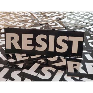 Multiple 'RESIST' stickers scattered on a surface